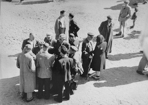 Jews converse outside in the Sammelstelle
